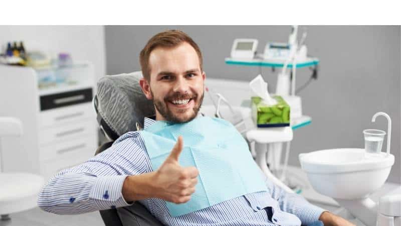 Happy patient in dentist's chair Happy patient in dentist's chair
