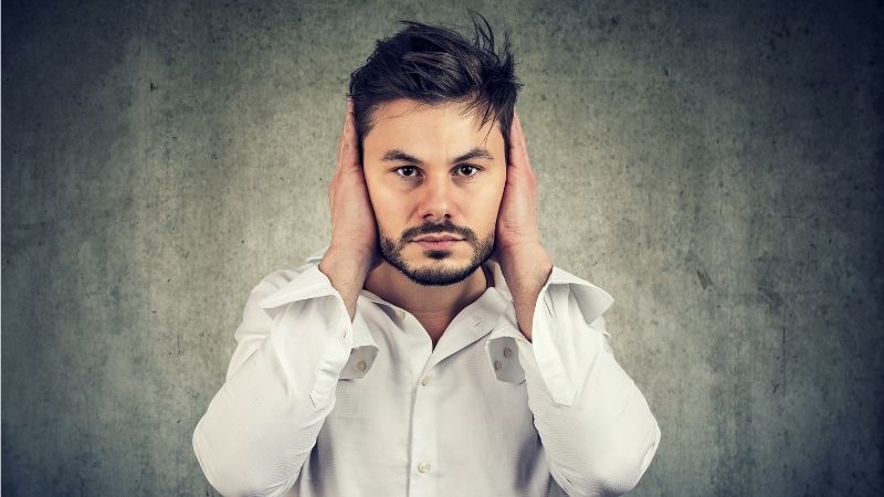 Man covering his ears Man covering his ears