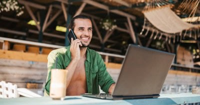 Digital nomad working on beach